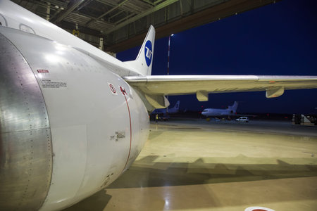 Turbine of the passenger plane close-up against the background of an aircraft hangar