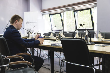 Ufa, Russia 24 May 2018: Business Forum - Oil and Technology. A man in a suit is sitting at the...