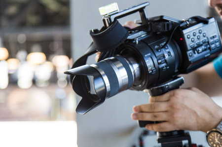 Professional camcorder and hand video operator close-up