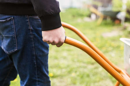 the man is holding a building wheelbarrow. garden workの写真素材