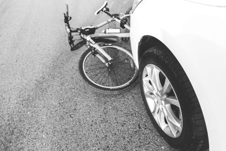 a close-up of a bicycle caught under the wheels of a car. accident on the road, accident, traffic...