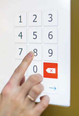 Woman using credit card for paying ticketing machine. entering the password on the touch-screen panel. credit paymentの写真素材
