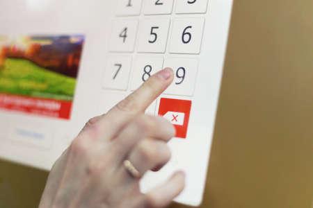 Woman using credit card for paying ticketing machine. entering the password on the touch-screen panel. credit paymentの写真素材