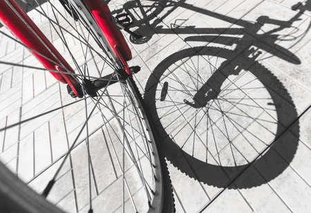 The bike and its shadow on the paving slab. View from above.の写真素材