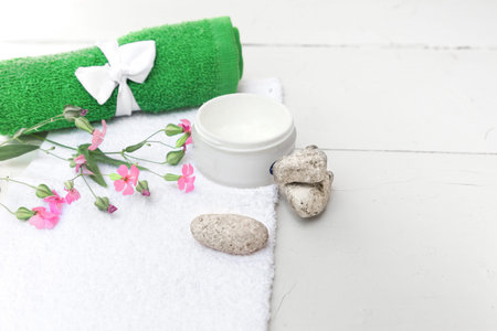 Spa beauty cosmetics on white marble table from above . Copy space