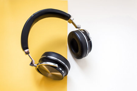 Fashion black headphones on yellow background. Urban Summer time