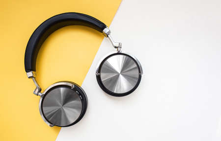 Fashion black headphones on yellow background. Urban Summer timeの写真素材
