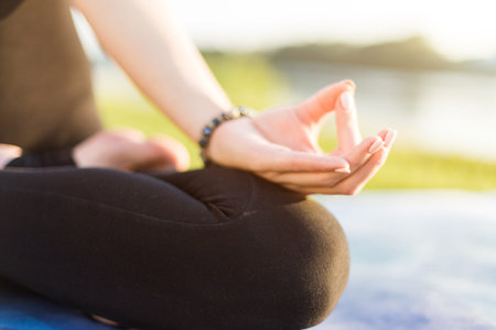 Beautiful young blonde girl doing yoga outdoors. close up