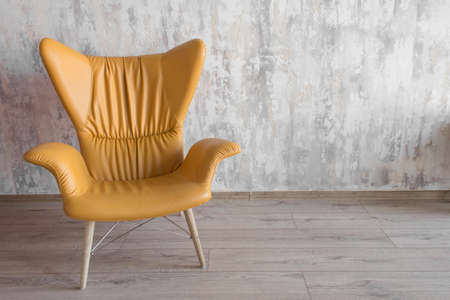 yellow modern armchair in an interior in a loft styleの写真素材
