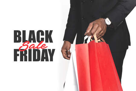 young businessman man African American with packages from the store goes shopping, rasprazhazha, black Friday, cyber Mondayの写真素材