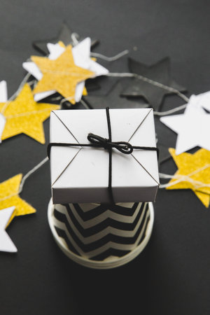 festive decoration of the table for the birthday or christmas party. stylish decorations on a black...