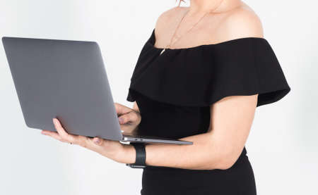 Beautiful young business woman using internet at laptopの写真素材