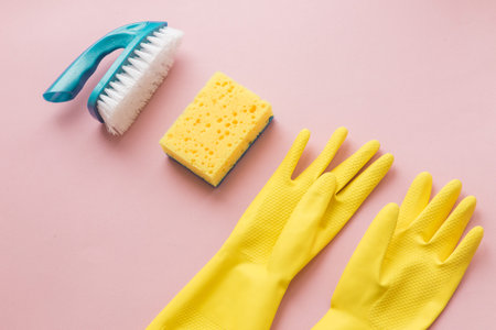 Flat lay Detergents and cleaning accessories in pink color. Cleaning service concept. Flatlay, Top...