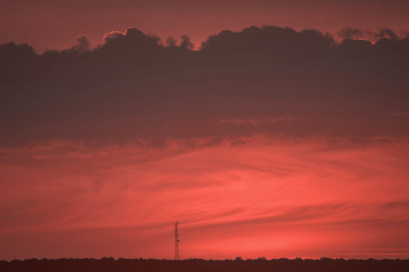 tower on the horizon against the background of the setting sun in the color of the year 2019 living...