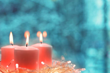 Christmas candles by the window. Color of the year 2019 living coral. livingcoral.の写真素材