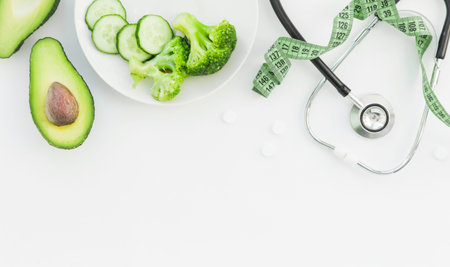 doctor nutritionist table. Healthy and healthy food, broccoli, pickers and avacado. Stethoscope and diet pills. Top View and flatlay, free space for text.の写真素材