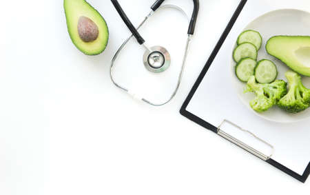 doctor nutritionist table. Healthy and healthy food, broccoli, pickers and avacado. Stethoscope and diet pills. Top View and flatlay, free space for text.の写真素材