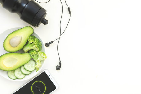 healthy lifestyle and fitness in sports, morning jogging. Sneakers, avocados, headphones and a water...