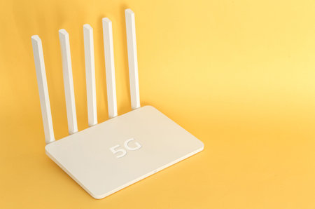 White 5g wifi router on a yellow  .
