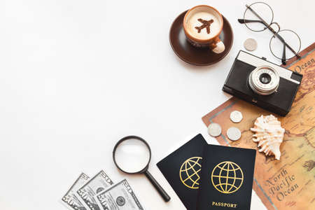 Top view of a table in the airport lounge, passports, a cup of coffee, a camera and a map.の写真素材