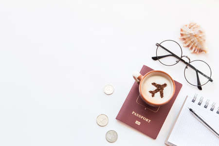 Top view of a table in the airport lounge, passports, a cup of coffee, a camera and a map.の写真素材