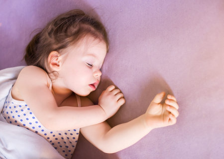 little cute baby sleeping soundly in her bed