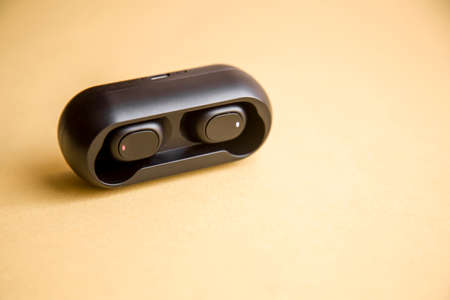 black Wireless headphones with microphone on yellow backgroundの写真素材