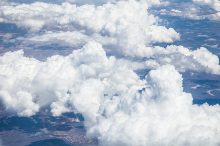Blue sky with white clouds during the afternoon. view from the airplane's illuminator. copy space...