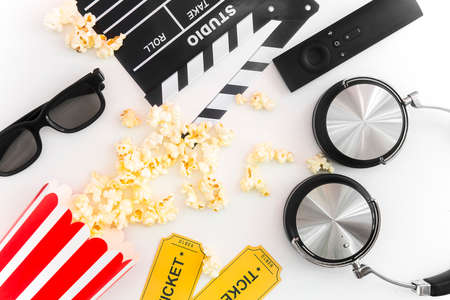 Cinema party concept. movie tickets, clapperboard, pop corn and 3d glasses in a whiteの写真素材