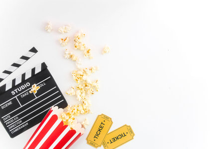 Cinema party concept. movie tickets, clapperboard, pop corn and 3d glasses in a white