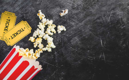 Cinema party concept. movie tickets, clapperboard, pop corn and 3d glasses in a blackの写真素材