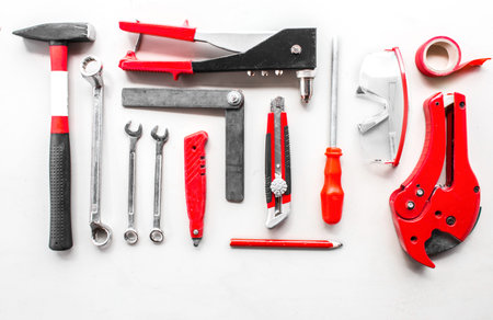 Set of carpentry red tools on wood