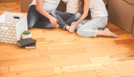 overhead view of family sitting on floor of a new home. moving to the cottage.の写真素材