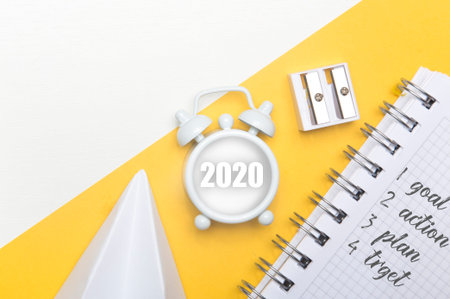 new goals for 2020. Composition flat lay. alarm clock on yellow background