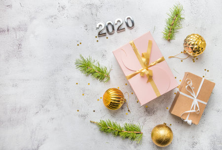 New Year's flatlay composition top view. Gift box with a bow, Christmas tree branches and free...