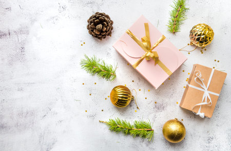 New Years flatlay composition top view. Gift box with a bow, Christmas tree branches and free space,...