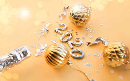 a bottle of champagne, Christmas toys and figures 2020. Christmas or New Year background, plain composition made of Xmas decorations and fir branches, flat lay, blank space for a greeting textの写真素材