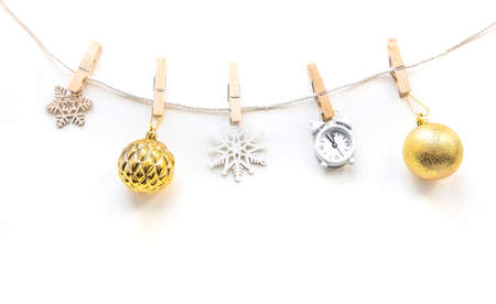 Golden balls toys, snowflakes on clothespins. Christmas composition on white background. Flat lay, top view, copy space.の写真素材