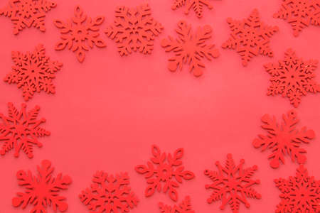 Snowflakes composition, red snowflakes on red background. Flat lay, top view, copy spaceの写真素材