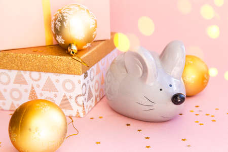 Christmas composition on a pink background. Boxes with gifts and the symbol of the Chinese New Year 2020 - Rat.の写真素材