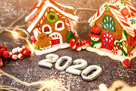 gingerbread, Christmas gingerbread house on the background of a New Year's garland.