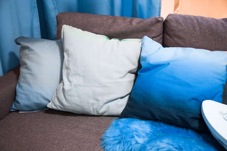 pillows and plaid on the armchair in the living room. classic blue color 2020.の写真素材