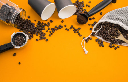 coffee house background with space for text. coffee beans, glasses, horn and mill on an orange...