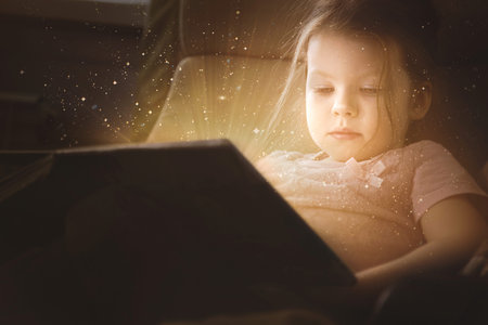 3 years old child reading magic book at home