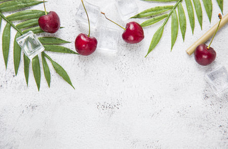 top view berry cherries and ice cube on a gray concrete background. Summer frash conceptの写真素材