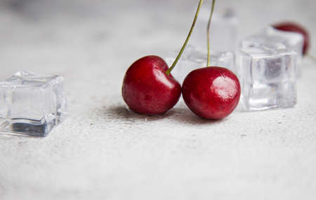 top view berry cherries and ice cube on a gray concrete background. Summer frash conceptの写真素材