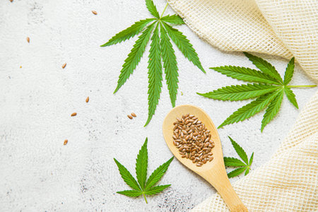flat lay composition top view. Marijuana leaves, cannabis oil and Hemp seeds. Cosmetics CBD oil.の写真素材