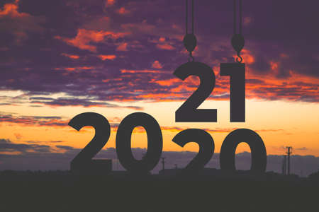 Sunset of 2020 year. digits 2021 against the sky. Goals, plans and tasks for the new year.の写真素材