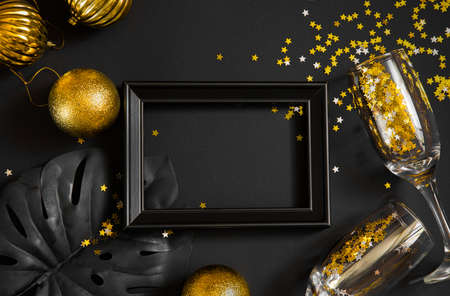 new year and christmas black background and gold decorations. background for text in a frame for a partyの写真素材