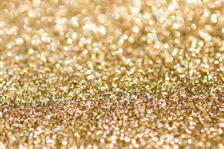 Abstract gold background with copy space. Glitter and bokeh. Christmas and new year concept.の写真素材